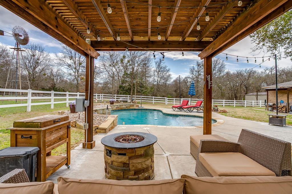 1615 Sanger Drive Springtown, TX 76082 - Photo 26 of 40 a view of a porch with furniture and a backyard