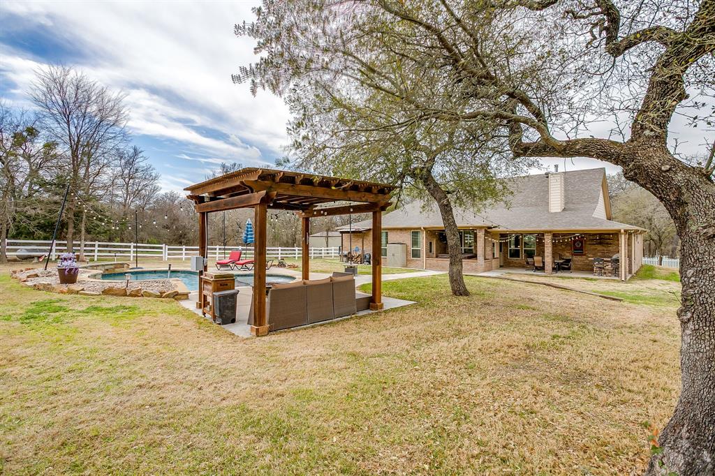 1615 Sanger Drive Springtown, TX 76082 - Photo 27 of 40 a view of a swimming pool with a bench in the patio