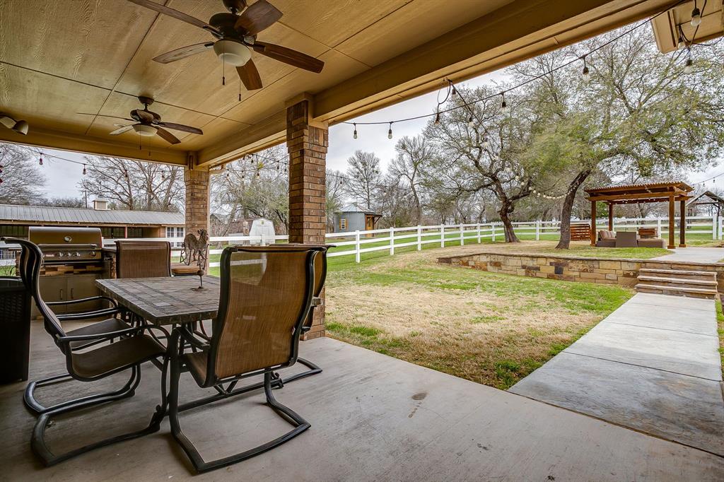1615 Sanger Drive Springtown, TX 76082 - Photo 29 of 40 a view of a patio with a table chairs and a yard