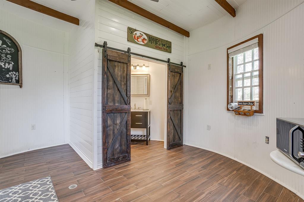 1615 Sanger Drive Springtown, TX 76082 - Photo 31 of 40 a view of empty room with wooden floor and fan