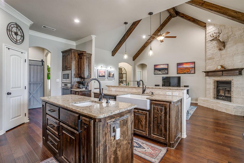 1615 Sanger Drive Springtown, TX 76082 - Photo 9 of 40 a kitchen with a sink and a stove top oven