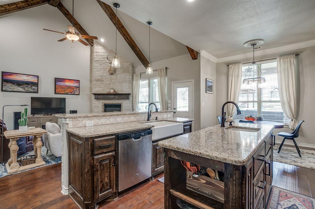 1615 Sanger Drive Springtown, TX 76082 - Photo 10 of 40 a open kitchen with stainless steel appliances granite countertop a stove and a refrigerator