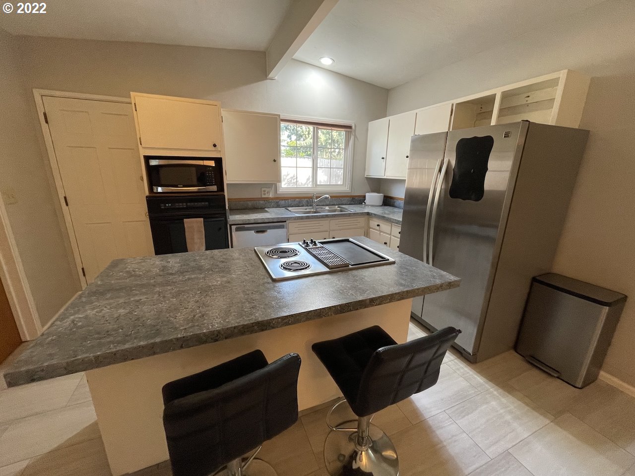 3203 Raleighwood Avenue Springfield, OR 97477 - Photo 10 of 28 a kitchen with stainless steel appliances kitchen island granite countertop a refrigerator a stove a sink and a refrigerator