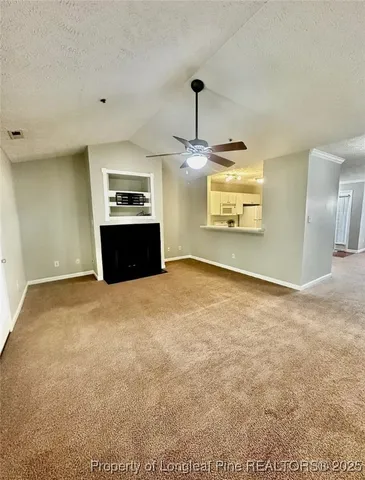 a view of a kitchen with a stove top oven and cabinets