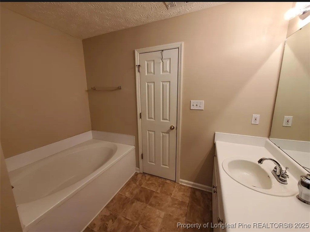 360 Bubble Creek Court, Unit 11 Fayetteville, NC 28311 - Photo 28 of 48 a bathroom with a tub sink and vanity