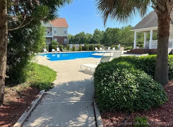 a view of a swimming pool with seating space