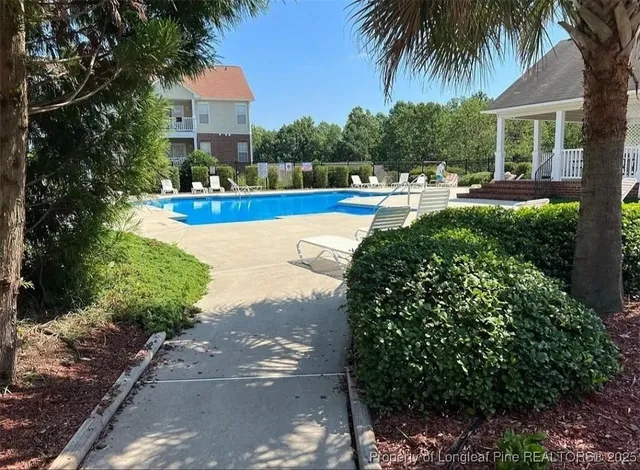 a view of a swimming pool with seating space