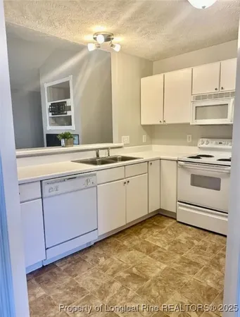 a kitchen with a sink stove and cabinets