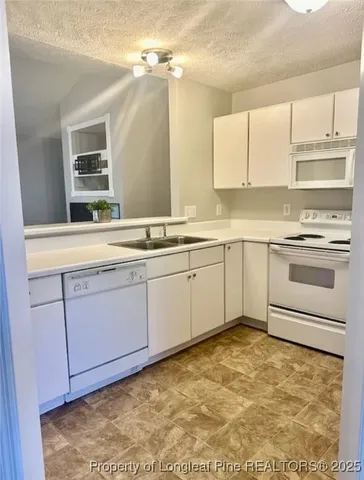 a kitchen with a sink stove and cabinets