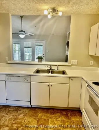 a view of a kitchen with a sink and dishwasher