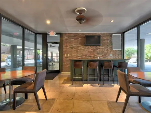 a kitchen with granite countertop a stove top oven microwave and cabinets
