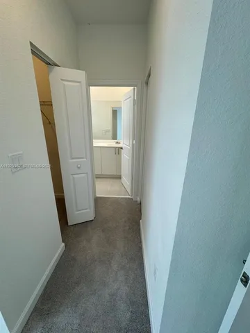 a view of a bathroom from a corridor