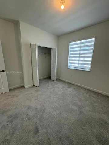 an empty room with a empty space and windows