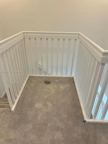 a view of an empty room with stairs