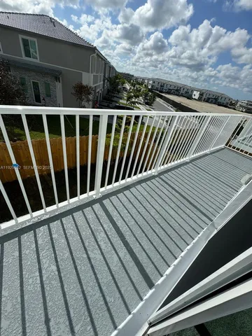 a view of balcony with wooden floor