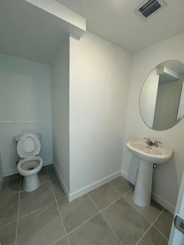 a bathroom with a shower sink and mirror