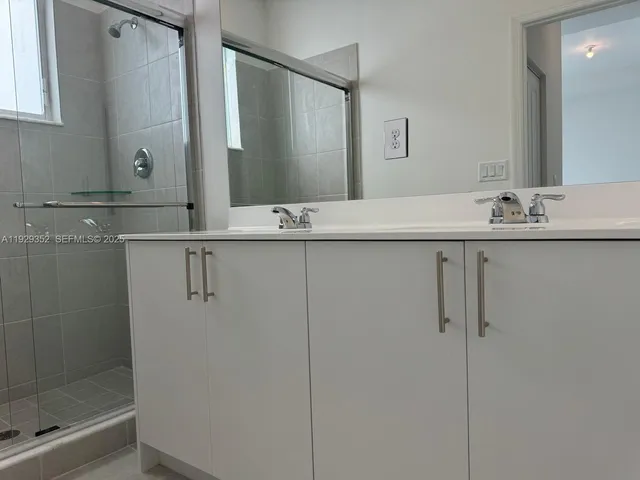 a living room with a couch and a view of kitchen