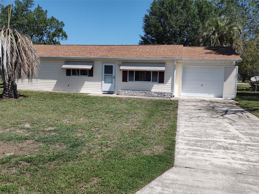 6345 Southwest 115th Street Road Ocala, FL 34476 - Photo 2 of 10 a front view of a house with a garden