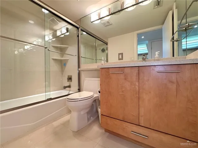 a bathroom with a toilet a sink and shower