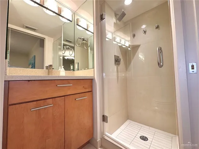 a bathroom with a shower and a mirror