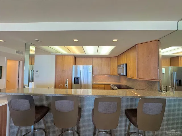 a kitchen with a table chairs sink and cabinets