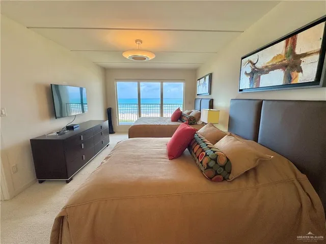 a bed room with a bed window and a television