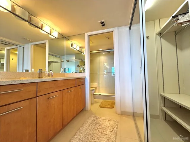 a bathroom with a shower and a sink