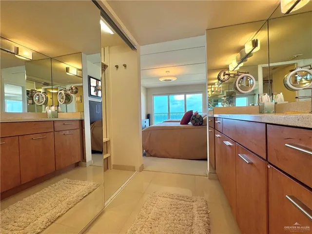 a bedroom with a bed a dresser and next to a window