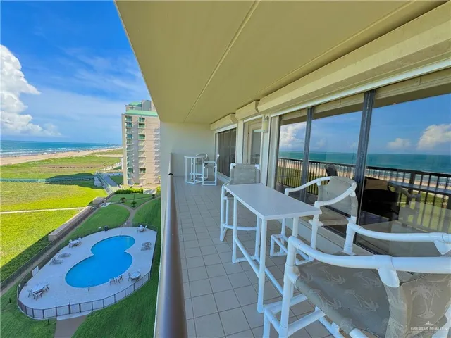 a view of a patio with chairs and potted plants