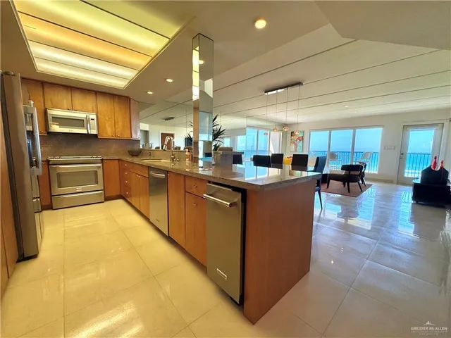 a kitchen with stainless steel appliances granite countertop lots of counter top space