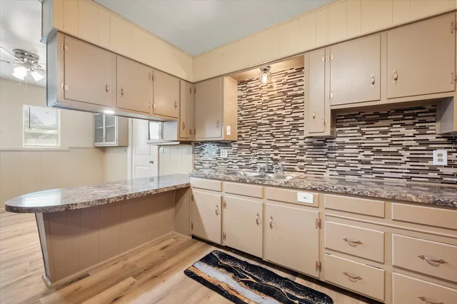 a kitchen with granite countertop white cabinets and white appliances