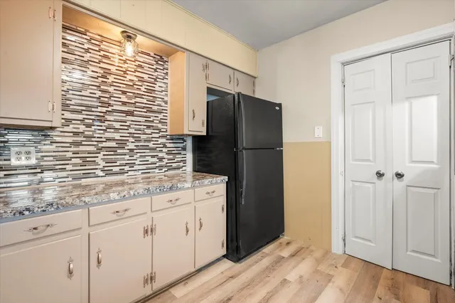 a kitchen with stainless steel appliances granite countertop a refrigerator and a sink