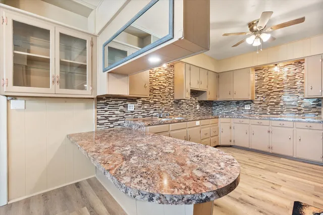 a view of a kitchen with a sink and wooden floor