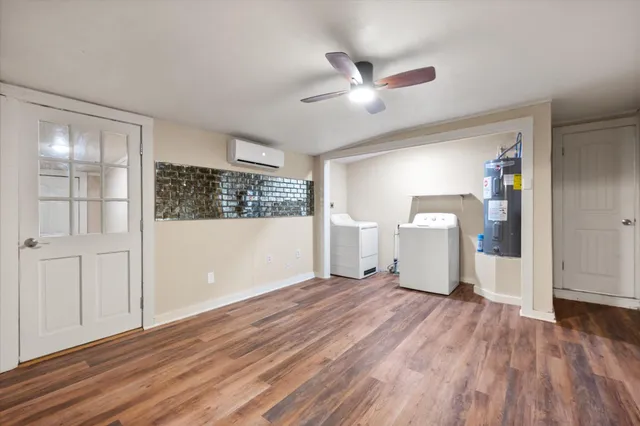 a view of empty room with wooden floor and window