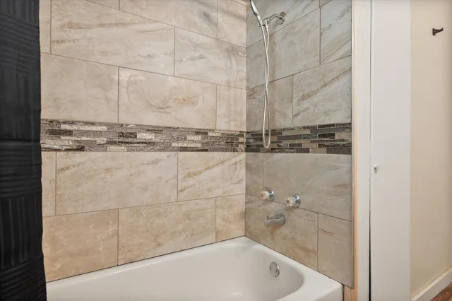 a bathroom with a bathtub and shower