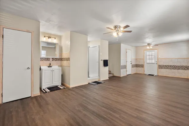 a view of a kitchen with a sink and a refrigerator