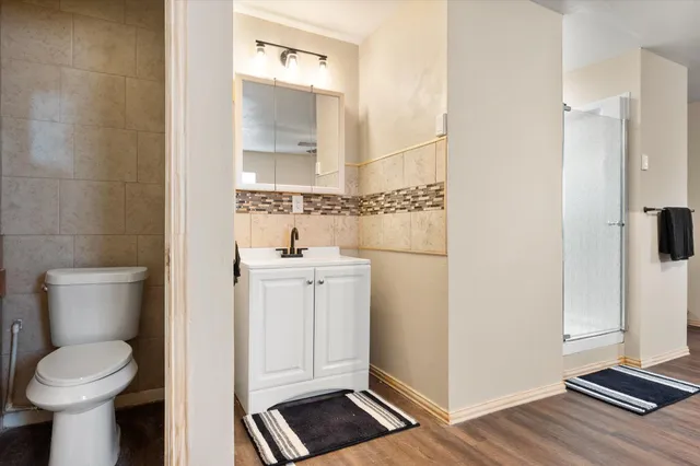 a bathroom with a toilet and a shower