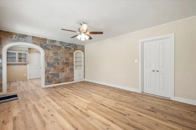wooden floor in an empty room with a window