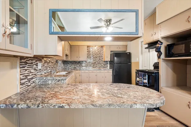 a kitchen with kitchen island sink refrigerator and stove