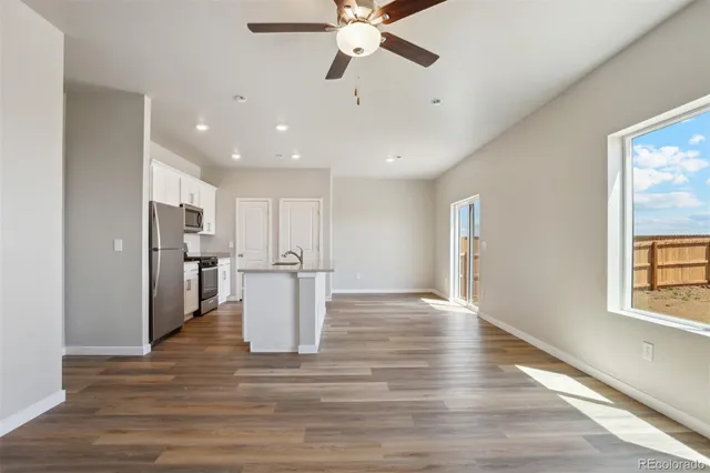 a view of a kitchen with a sink and wooden floor