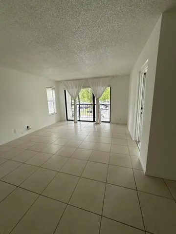 a view of an empty room with windows