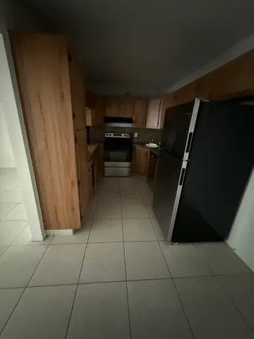 a kitchen with a refrigerator a stove top oven and a dishwasher