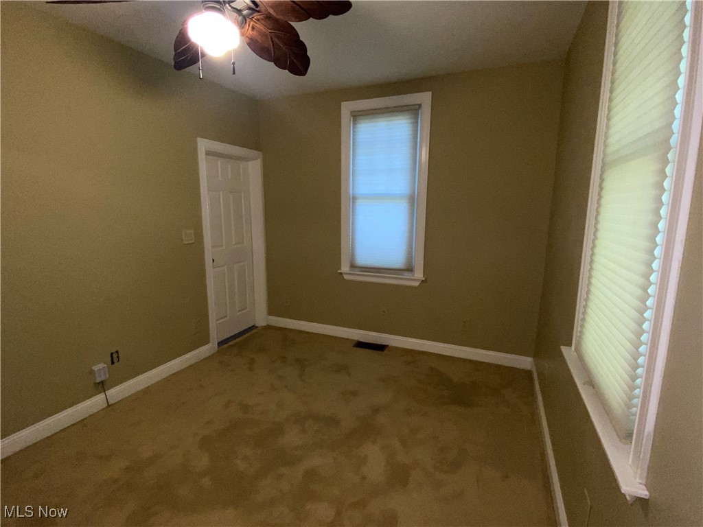 3016 Wadsworth Road Norton, OH 44203 - Photo 22 of 50 First floor carpeted bedroom with ceiling fan and cellular blinds