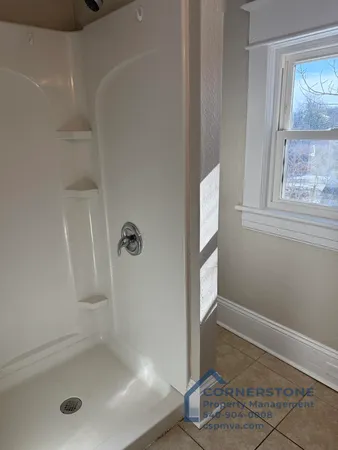 a bathroom with a bath tub and glass door