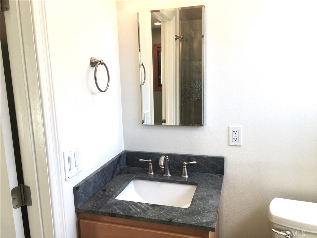 10011 Bernice Circle Buena Park, CA 90620 - Photo 11 of 28 a bathroom with a sink a toilet and mirror