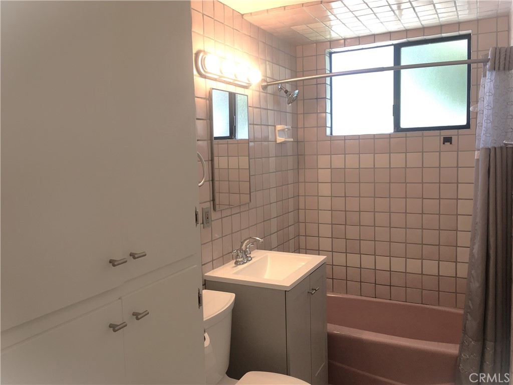 10011 Bernice Circle Buena Park, CA 90620 - Photo 12 of 28 a bathroom with a sink a bathtub and window