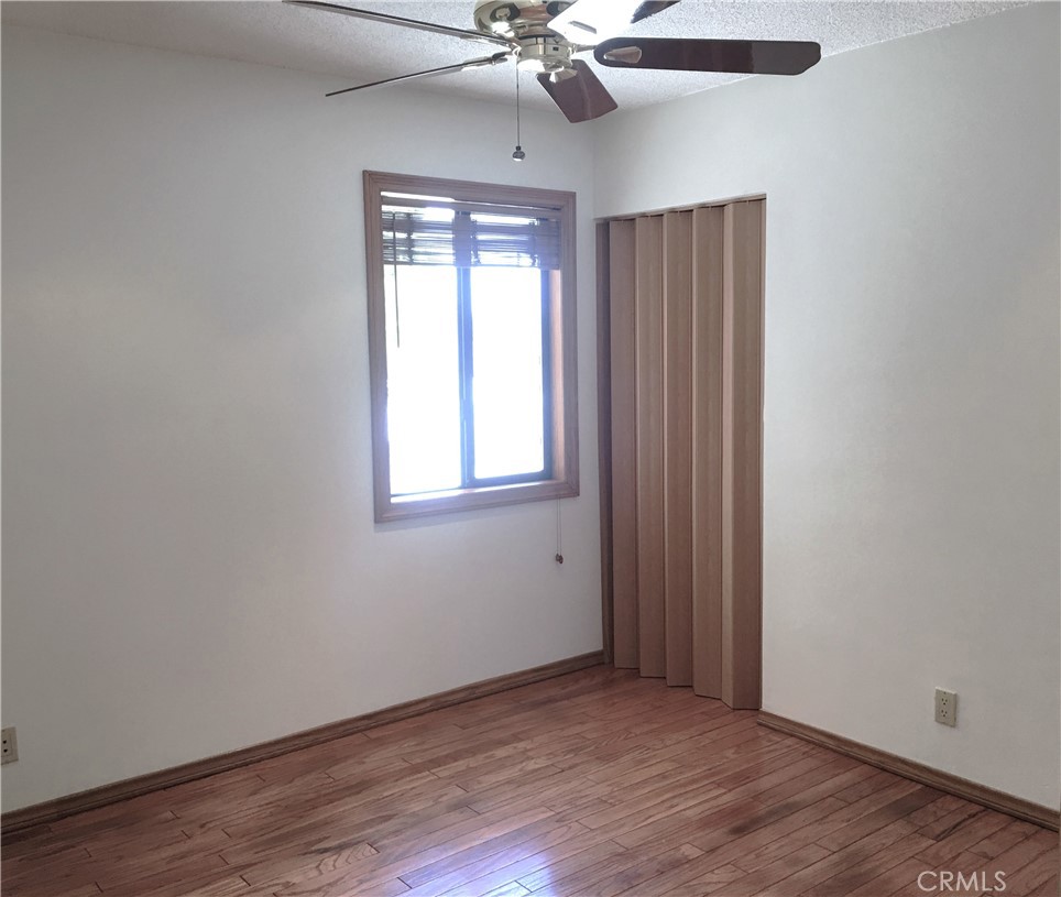 10011 Bernice Circle Buena Park, CA 90620 - Photo 13 of 28 an empty room with wooden floor fan and windows