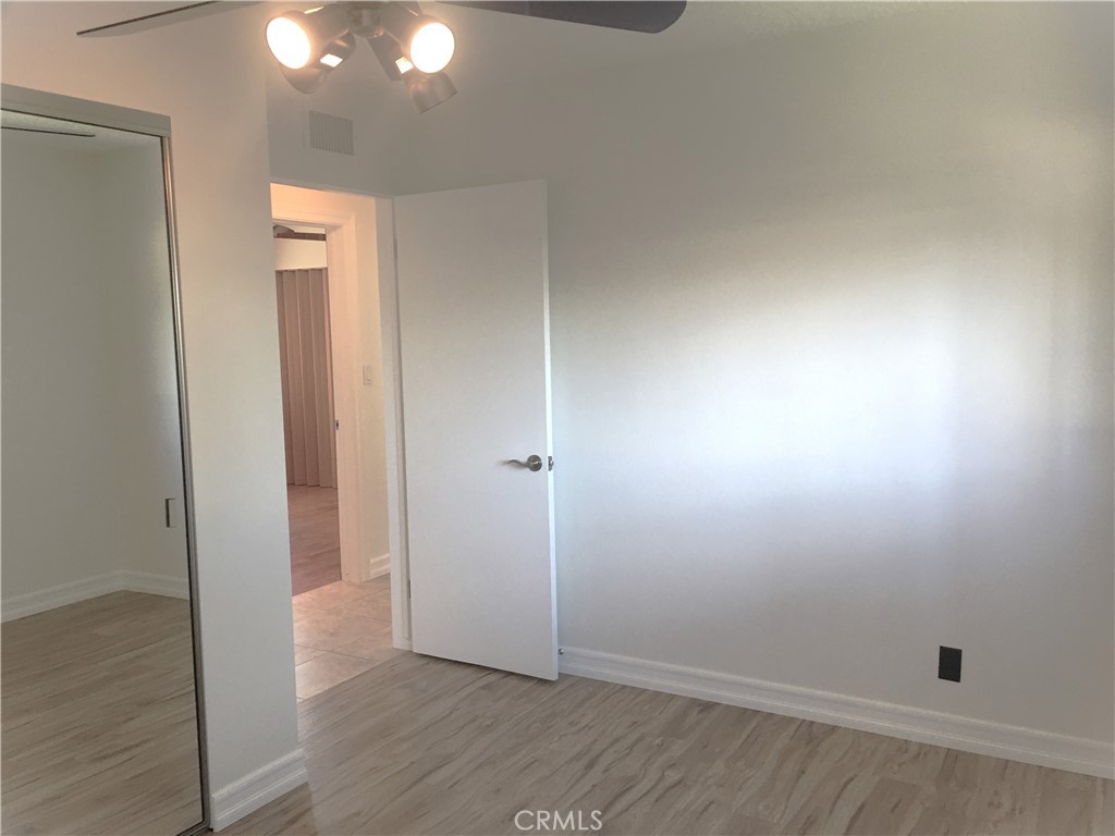 10011 Bernice Circle Buena Park, CA 90620 - Photo 17 of 28 an empty room with wooden floor and windows