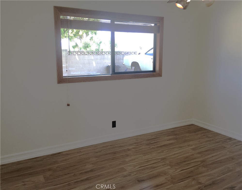10011 Bernice Circle Buena Park, CA 90620 - Photo 18 of 28 an empty room with wooden floor and windows