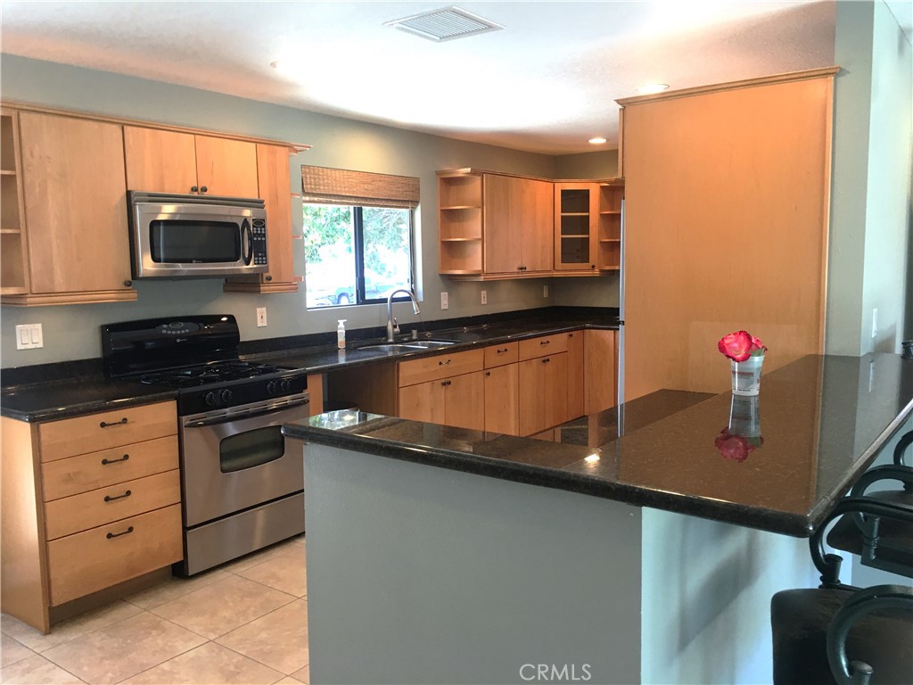 10011 Bernice Circle Buena Park, CA 90620 - Photo 5 of 28 a kitchen with stainless steel appliances granite countertop a sink and a microwave